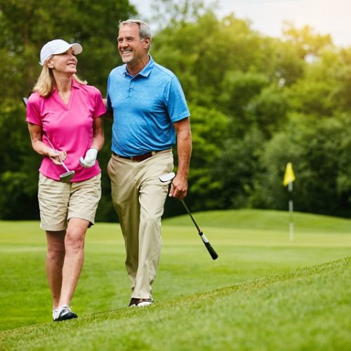 Shot of a mature couple on a golf course